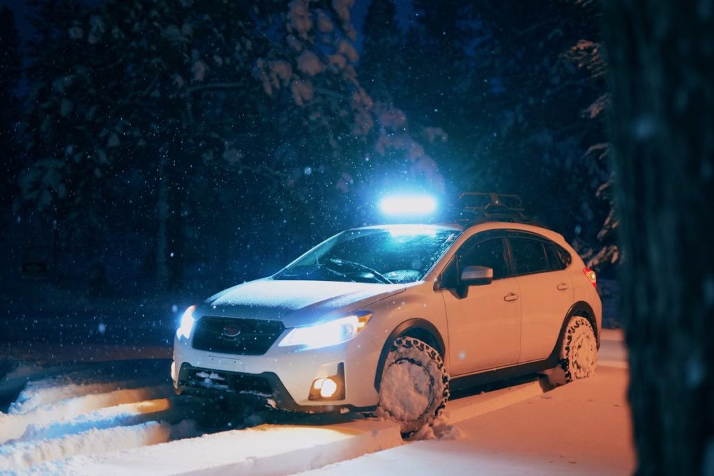 A car is stuck on the road full of snow.